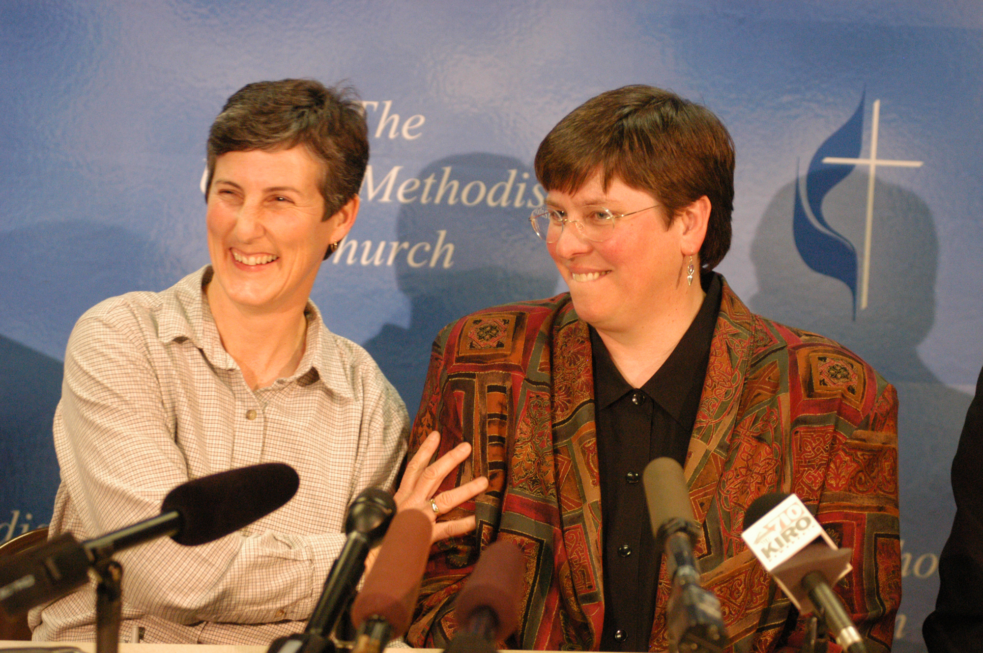 The Rev. Karen Dammann (right) and her partner, Meredith Savage, share a light-hearted moment at a news conference following Dammann's clergy trial. A trial court of 13 pastors acquitted Dammann of charges that could have resulted in the loss of her ministerial orders. A UMNS photo by Les Fetchko.