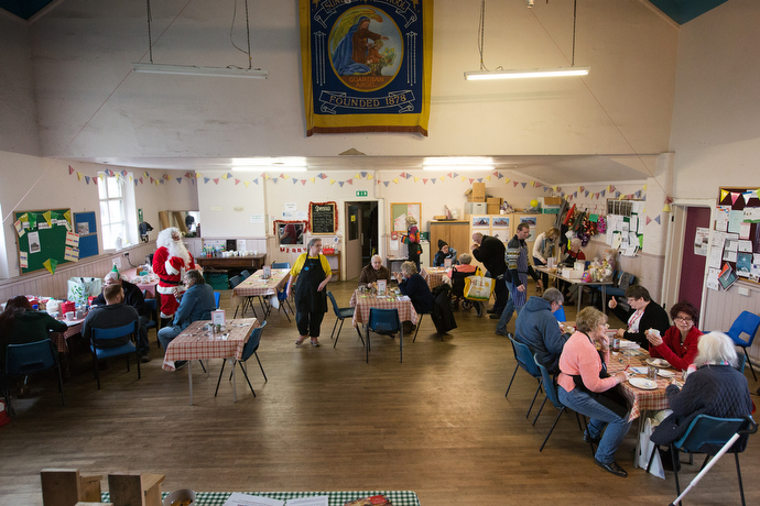 Church members, volunteers and community members gather for fellowship and a meal at the community cafe during the Christmas season. Photo by Mike DuBose, UMNS.