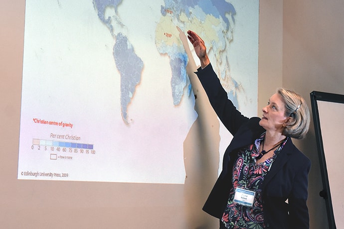 Dana Robert points to a global map featuring percentages of Christians worldwide during a session to provide training for leaders of churches impacted by migration. The United Methodist Board of Global Ministries sponsored the event Aug. 22-30 at The United Methodist Church of Germany Educational and Training Center in Stuttgart, Germany. Photo by Üllas Tankler, Board of Global Ministries.
