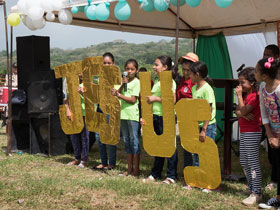 Children sang and read scripture behind large letters spelling out Jesus as part of the celebration of placing the cornerstone for Casa de Paz United Methodist Church. Photo by Kathy L. Gilbert, UMNS.