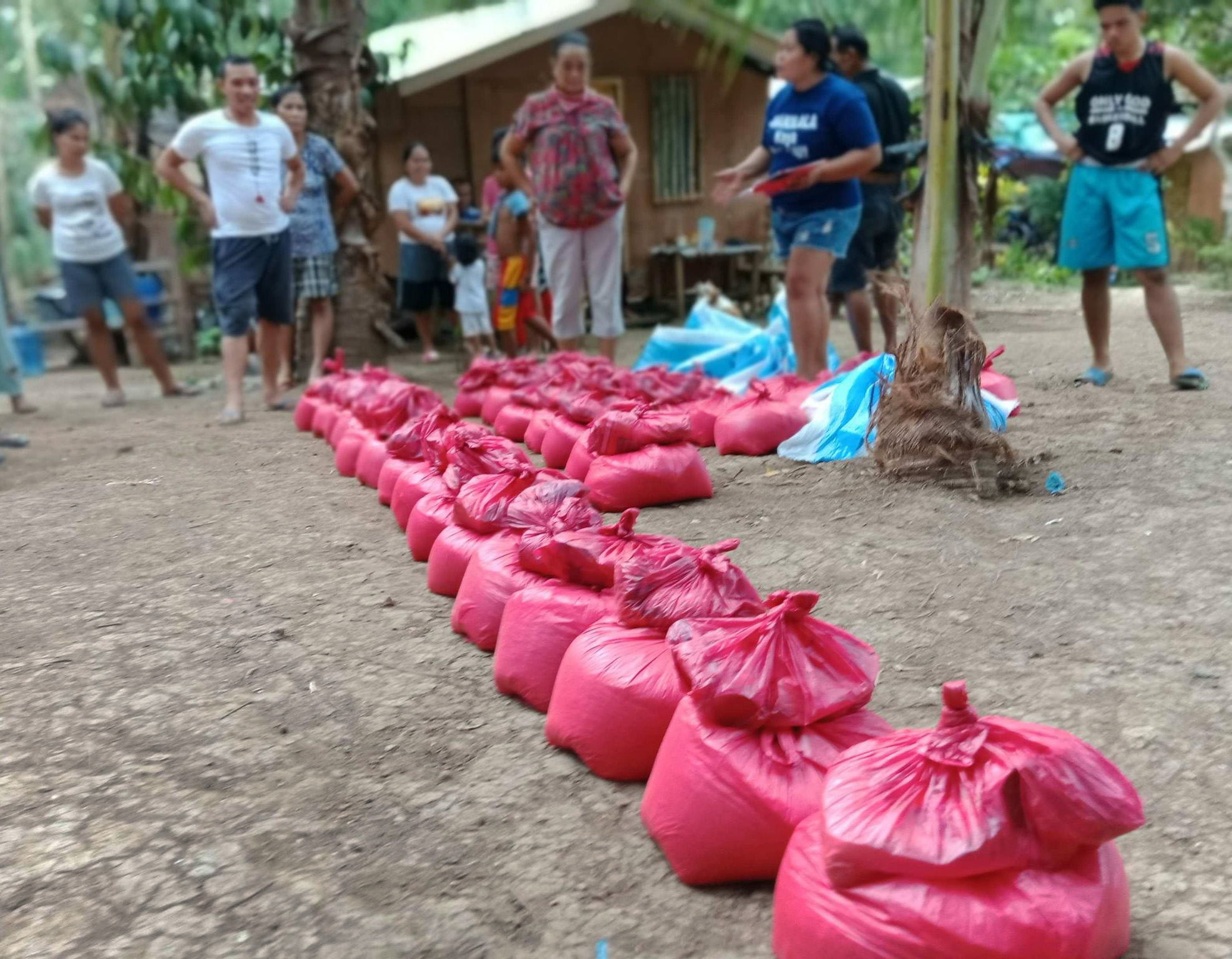 United Methodists, led by the Rev. Recto Baguio, superintendent of the Mindanao Central East District, distribute food to communities struggling during the coronavirus pandemic in the Philippines. The relief packs include rice, canned goods, noodles, sugar, salt, dried fish and soap. Photo courtesy of the Rev. Recto Baguio.