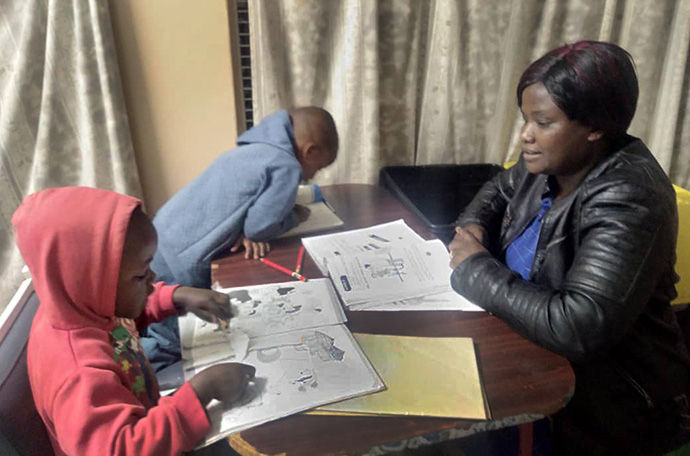 Nurse Norah Mutanga instructs her children, Kunashe and Ethan, at their home in Chisipiti, Zimbabwe. Like Susanna Wesley, who taught her children at home, more parents are helping with their kids’ education as schools remain closed or switch to e-learning. Photo by Kudzai Chingwe, UM News.