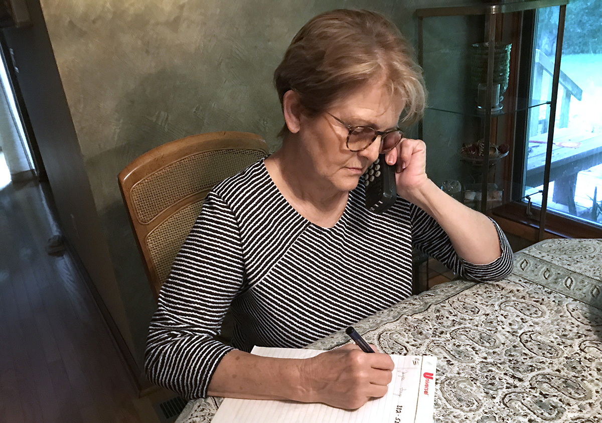 Linda Dobbyn, a parishioner at Vincennes First United Methodist Church in Vincennes, Ind., uses a new service called Sermon by Phone to listen to a sermon by the Rev.  Matt Swisher titled “Leading by Serving.” Photo by Richard Dobbyn.