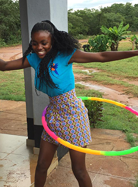 Nineteen-year-old Winnet Mandikisi, an orphan who spent her teenage years at The United Methodist Church’s Home of Hope, has fun with a hula hoop at Nyadire Mission in Mutoko, Zimbabwe. Mandikisi has been teaching orphans at the home how to make masks and sanitary pads while schools have been closed during the coronavirus pandemic. Photo by Chenayi Kumuterera, UM News.