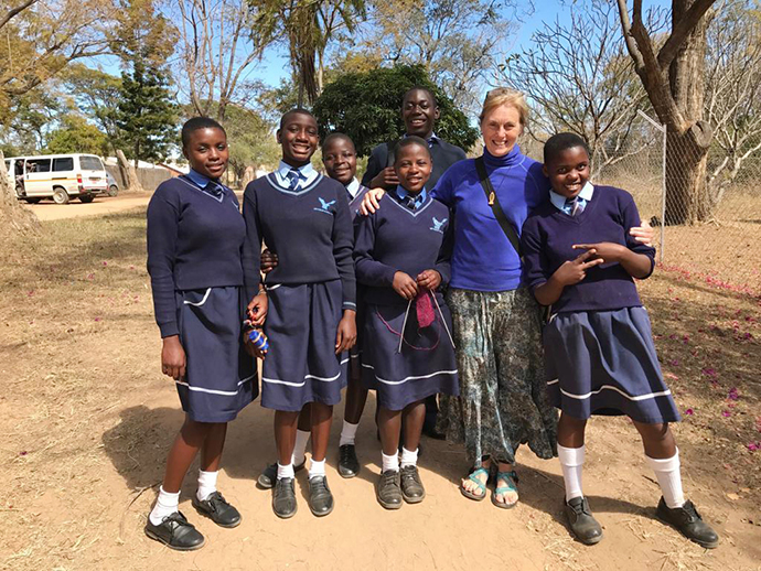 Mary Beth Zollars (second from right) with the Nyadire Connection stands with students, including Winnet Mandikisi (left), at The United Methodist Church’s Home of Hope orphanage. Photo by Chenayi Kumuterera, UM News.