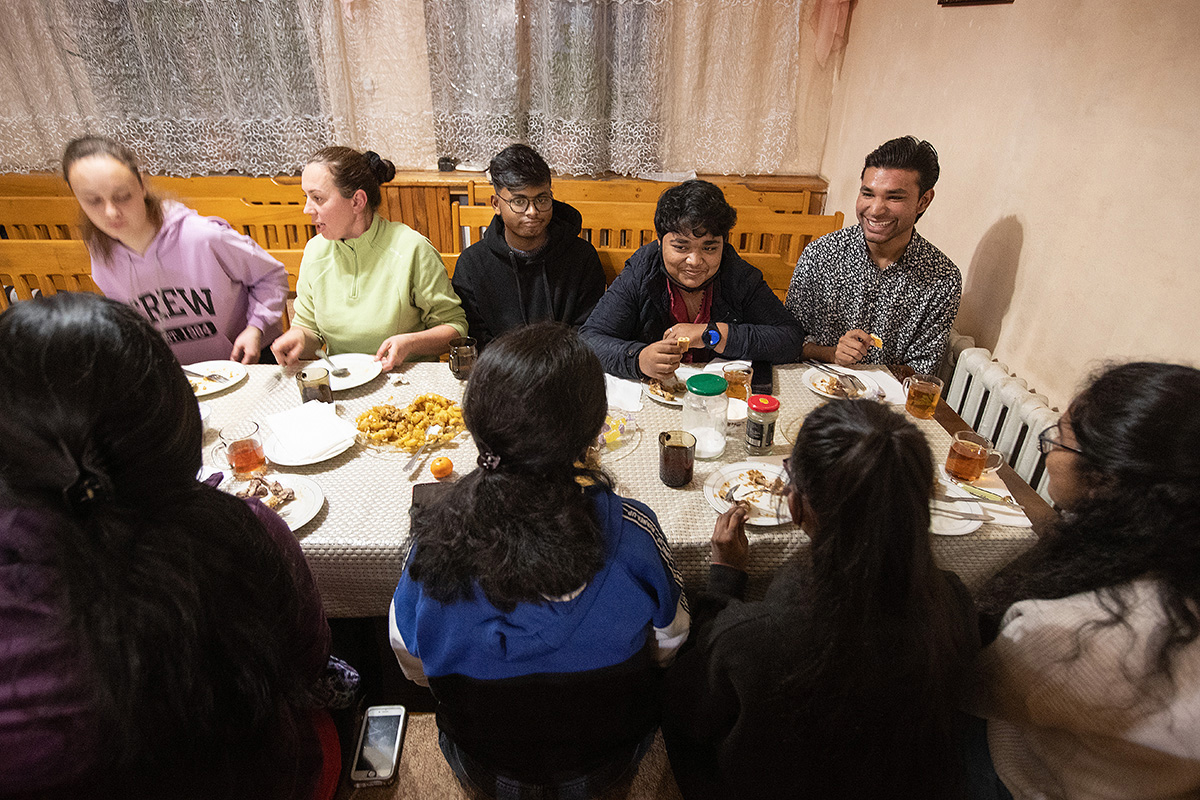 The Rev. Nellya Shakirova (wearing green shirt) hosts a multinational fellowship meal in the sanctuary at Bishkek United Methodist Church in Bishkek, Kyrgyzstan. Photo by Mike DuBose, UM News.