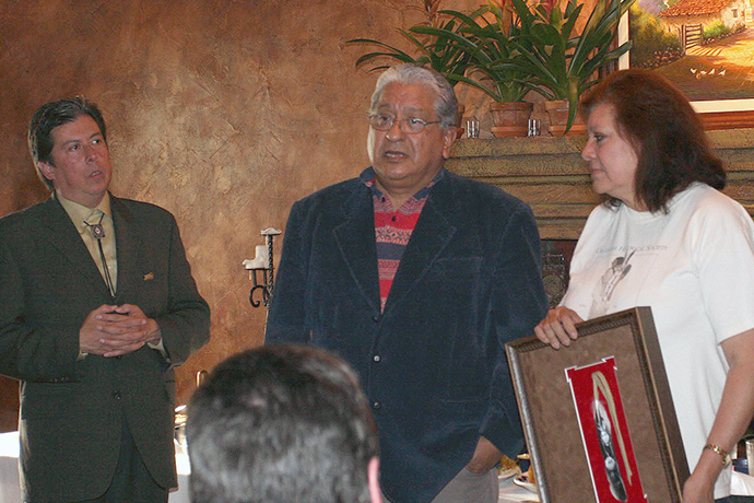 Bishop David Wilson (left), before being elected as a bishop in 2022, honors the Rev. Alvin Deer, a United Methodist minister and a member of the Kiowa and Creek tribes, at a 2008 dinner sponsored by the Native American Comprehensive Plan, held near the Fort Worth (Texas) Convention Center, site of that year’s United Methodist General Conference. At right is Deer’s wife, Laura. File photo by Ginny Underwood.