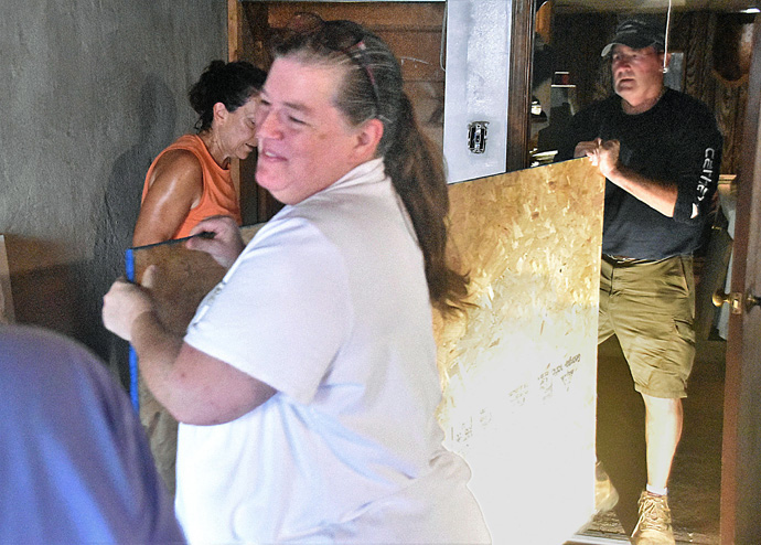 Denise Shelton (center), disaster recovery director for Project Restoration, assists volunteers as they work June 30 in the basement of Brenda Wyatt’s home in Collingdale, Pennsylvania. Project Restoration’s work is financed by donations from individuals and churches and grants from the United Methodist Committee on Relief. Photo by John Coleman, Eastern Pennsylvania Conference.