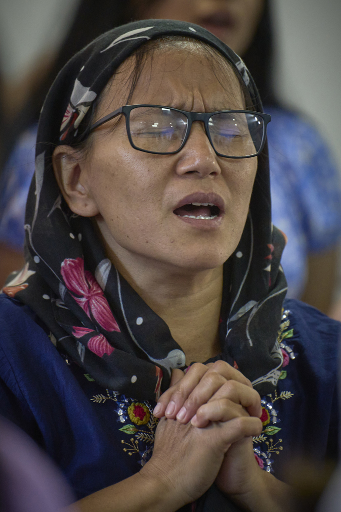 Meena Moktan prays during worship May 20 at Hebron United Methodist Church in Lalitpur, Nepal. Moktan coordinates a women's empowerment program for the church. Photo by Paul Jeffrey, UM News.