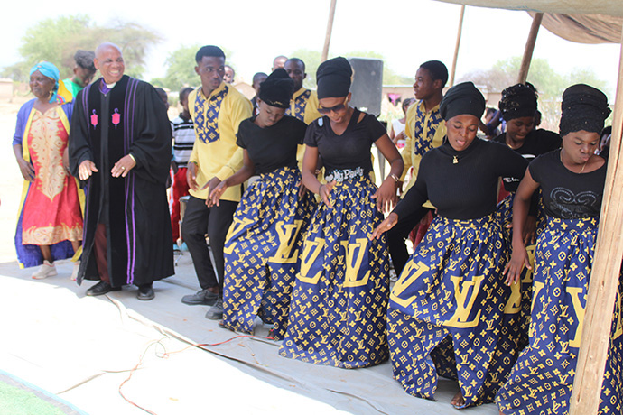 Bishop Eben K. Nhiwatiwa (in robe) dances with members of the choir at the United Methodist preaching point at the Tongogara Refugee Camp. Photo by Kudzai Chingwe, UM News.