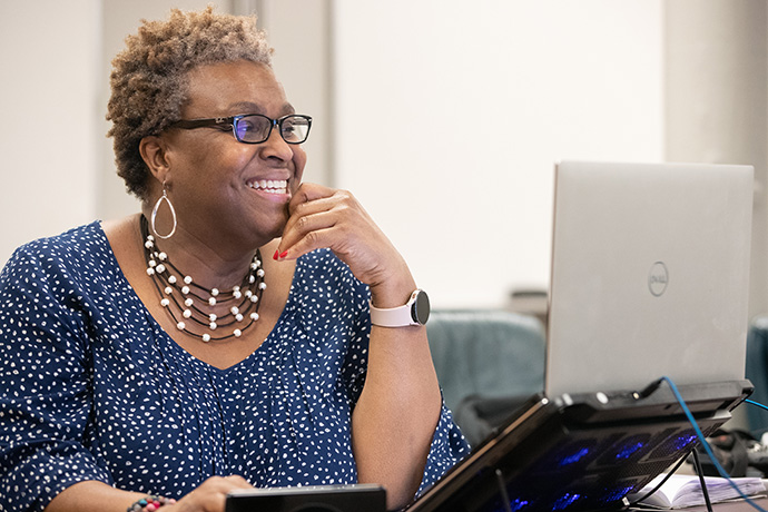 Tina Boone smiles while hosting dial-in worship at Gordon Memorial United Methodist Church in Nashville, Tenn. The COVID-19 pandemic “taught us that you don’t only have to go into church. You can worship in other ways and still be OK with that,” she said. Photo by Mike DuBose, UM News.