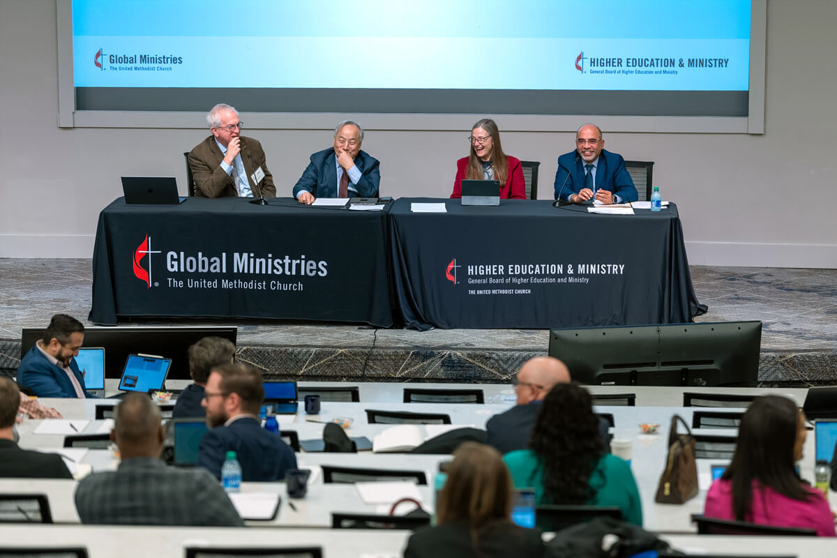 A moment of levity brings smiles during the first joint board meetings of the United Methodist Board of Global Ministries and United Methodist Board of Higher Education and Ministry that took place March 4-8 at Emory University in Atlanta. At the tables are (left to right) the Rev. Greg Bergquist, top executive of GBHEM; Bishop Hee-Soo Jung, president of the Global Ministries board; Bishop Sandra Steiner Ball, president of the board of Higher Education and Ministry; and Roland Fernandes, top executive of Global Ministries and the United Methodist Committee on Relief. Photo by Adam Bowers, Global Ministries.