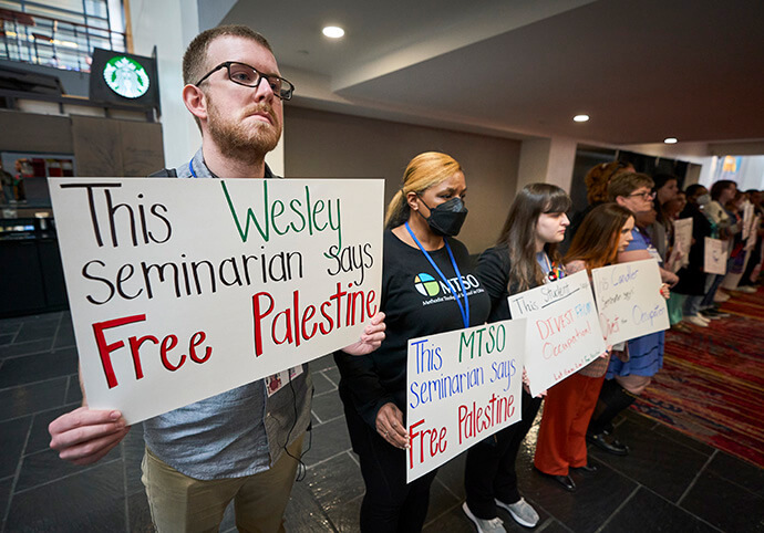 Erik Slingerland, a reserve delegate from the Illinois Great Rivers Conference, holds a sign during a demonstration in support of the people of Gaza held during the United Methodist General Conference in Charlotte, N.C., on April 30. Photo by Paul Jeffrey, UM News.