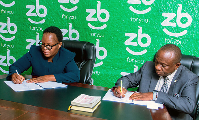 Letwin Mawire (à gauche), directeur de ZB Life Assurance, et le révérend Alan M. Gurupira, assistant administratif de l'évêque de la Région Épiscopale du Zimbabwe, signent un accord historique pour le plan d'obsèques en espèces de l'Église Méthodiste Unie à Harare, au Zimbabwe. Photo reproduite avec l'aimable autorisation de ZB Holdings Limited.