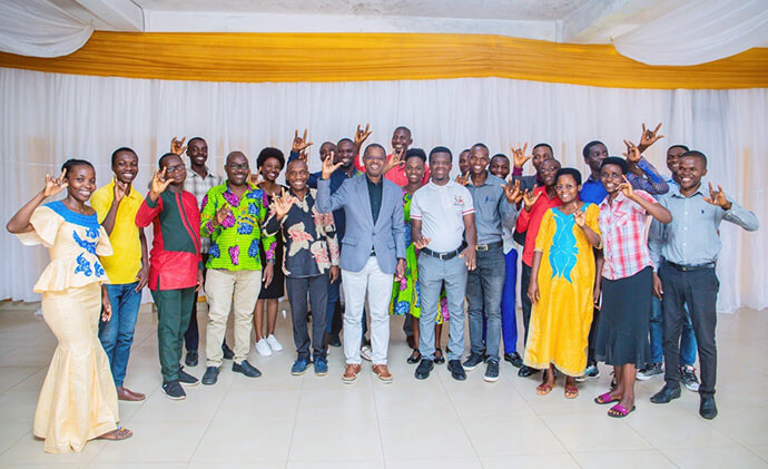 The Rev. Emmanuel Sinzohagera (center, blue jacket), Prempeh Collins Kwasi (to his left) and United Methodist lay and clergy raise their hands to say “I love you” in sign language during a training course sponsored by the church in Burundi. This new ministry will enable some 588 United Methodists who are Deaf or have partial hearing loss to participate in and understand the essential messages of the church during worship and meetings. Photo by Rev. Niyiragira Ladislas, UM News.