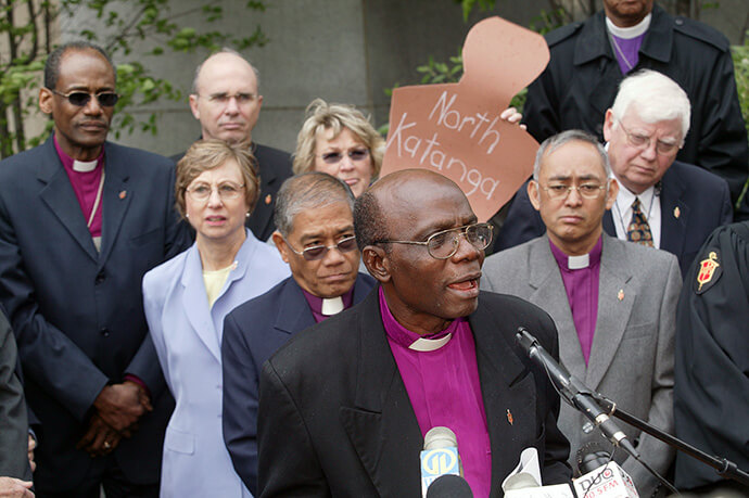 United Methodist Bishop Joseph C. Humper of Sierra Leone, flanked by a number of fellow bishops, speaks out about the U.S. government's denial of visas for some United Methodists from Africa and the Philippines during a press conference at the 2004 United Methodist General Conference in Pittsburgh. File photo by Mike DuBose.