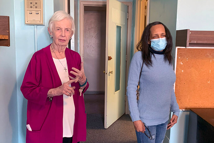 Carolyn Marshall, left, executive director of the Lucille Raines Residence in Indianapolis, and Mariea Strader, program coordinator and a former resident, display the room of one of the program’s clients. Photo by Joey Butler, UM News.