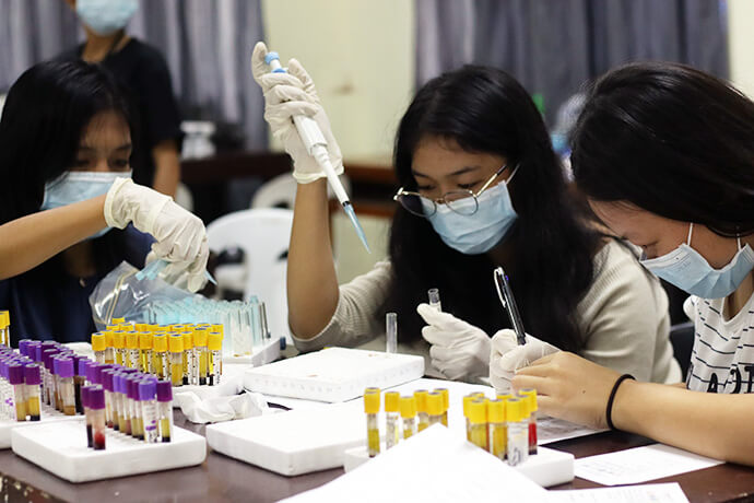 Youth volunteers perform blood sample mixing during a medical mission at Spottswood Methodist Center in Kidapawan, Philippines. Most of the youth volunteers were medical students who had the opportunity to hone their skills during the event sponsored by The United Methodist Church in the Philippines in partnership with local nonprofits and Wesleyan University-Philippines. Photo courtesy of Davao Episcopal Area Communications.