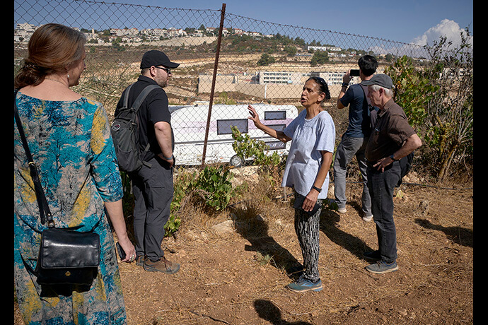 Amal Nassar shows a visiting delegation of U.S. church activists a trailer that has been moved onto land beside her family farm near Bethlehem. Known as the Tent of Nations, the farm is an educational and environmental center that sits on the last remaining Palestinian hilltop in the middle of the Gush Etzion settlement block near Bethlehem, in the occupied West Bank. The Christian Palestinian family remains under constant threat from settlers and the Israeli military. The trailer was moved there in May 2024, in what Nassar believes is an attempt to establish justification for expelling the Christian family. Photo by Paul Jeffrey, UM News.
