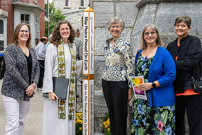 The Rev. Anna Layman Knox (second from left), pastor of Grace United Methodist Church in Harrisburg, Pa., poses with church members by the congregation’s “Peace Pole.” The pole was installed to signify the church’s stand for peace. Knox and her congregation prayed for the presidential candidates and the nation ahead of the U.S. elections. Photo courtesy of Grace United Methodist Church.