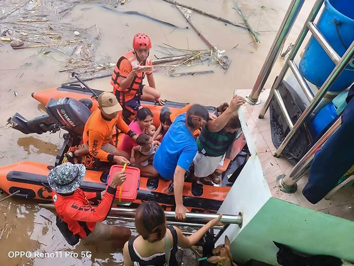 Philippine Coast Guard personnel ferry residents to safety after floodwaters rose quickly in the Bicol region as rain from Tropical Storm Trami pounded the area on Oct. 24. Photo courtesy of the Ako Bicol Online TV Facebook page.