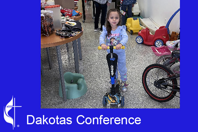 A child chooses a scooter at a Kids Free Christmas Shopping event sponsored by ARK and Velva United Methodist churches in North Dakota. Photo courtesy of the Dakotas Conference Facebook page.