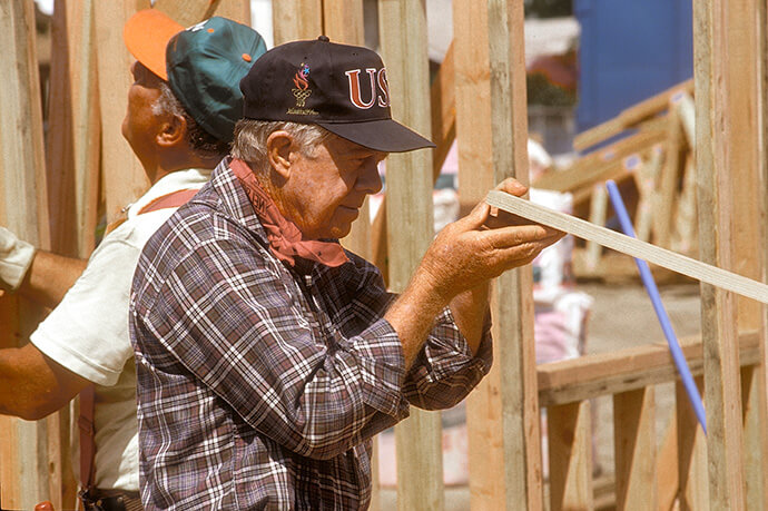 Beginning in 1984, Jimmy and Rosalynn Carter volunteered one week a year to build homes for Habitat for Humanity. Jimmy Carter is pictured here working in the Watts/Willowbrook community of Los Angeles in 1995. Photo courtesy of Habitat for Humanity.
