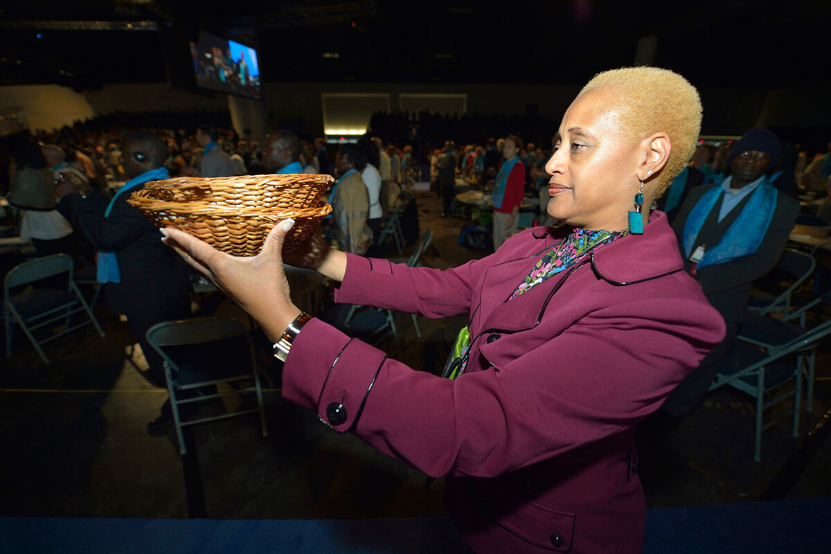 The Rev. Johnsie Whitfield Cogman helps collect the offering during opening worship service of the 2012 United Methodist General Conference in Tampa, Fla. Overall giving to denomination-wide ministries was down in 2024, compared to 2023. But the denomination’s financial leaders are hopeful that the significantly smaller budget approved at last year’s General Conference in Charlotte, N.C., will be much more in line with the denomination’s giving capacity. File photo by Paul Jeffrey, UM News.