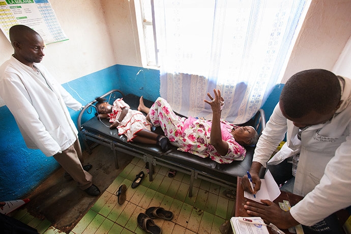 Gael Nonge (left, on bed) shares a hospital bed with Margelitte Enanga at The United Methodist Church's Irambo Health Center in Bukavu, Congo, in this 2015 file photo. In February, the hospital was a target during clashes between the M23 rebels and Congolese armed forces. Photo by Mike DuBose, UM News.