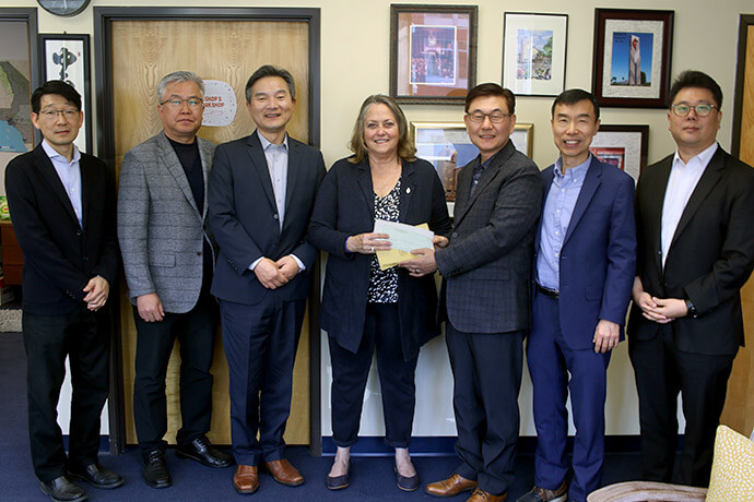 Bishop Dottie Escobedo-Frank receives more than $18,000 in support for wildfire recovery from executive committee members of the Association of the Korean United Methodist Church of the California-Pacific Conference on Feb. 24. The donations were collected from Korean congregations and non-Korean congregations led by Korean pastors. From left are the Revs. Christian Jung, Jacob Lee and Changmin Lee, Bishop Escobedo-Frank, and the Revs. Brian Lee, Sungki Lee and Jay Jeon.  Photo by the Rev. Thomas E. Kim, UM News.