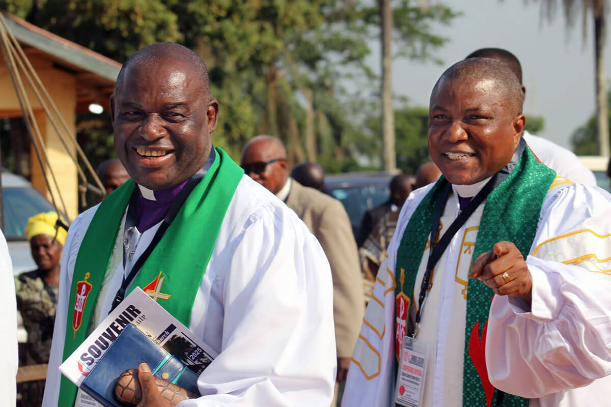 Bishop Samuel J. Quire Jr. (right), who leads The United Methodist Church’s Liberia Conference, walks beside Bishop James Boye-Caulker of the Sierra Leone Conference during the 192nd session of the Liberia Annual Conference, held Feb. 10-16 in Gbarnga, Liberia. Quire said the church was fighting for control of several sanctuaries in Liberia that were seized by members of the Global Methodist Church following the annual conference session. Photo by Priscilla Muzerengwa, United Methodist Communications.