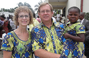 Susie and Ed Keefer pose with Miriam, age 4, in Kinshasa, Congo, in 2013. Shortly afterward, Miriam went home with the Keefers to the United States. The matching outfits were a gift from Dr. Rebecca Yohadi. Photo courtesy of Susie Keefer.