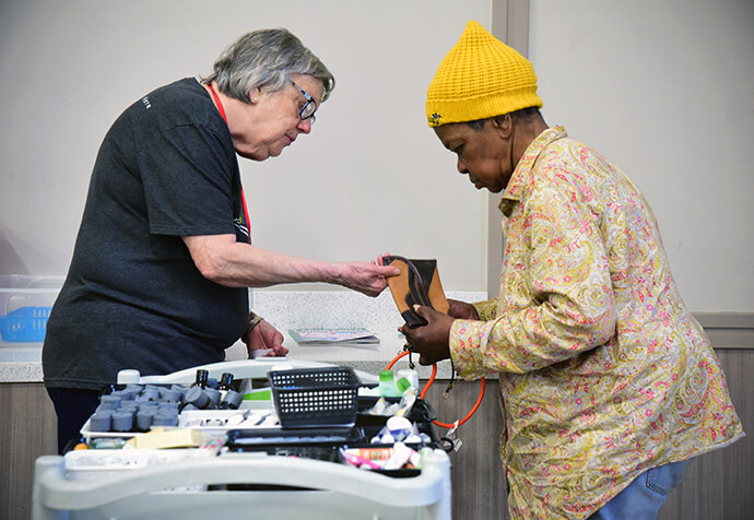 Karen Janes (left), a volunteer at First United Methodist Church of Austin, helps Dawn, a homeless woman in the city, pick out some items to help her survive on the streets. Photo by Andrea Turner, UM News.