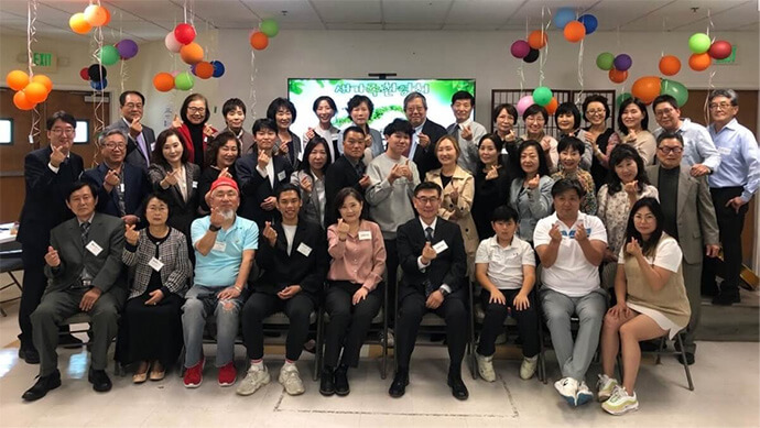Members of Los Feliz United Methodist Church in Los Angeles pose for a photo in celebration of 21 new members joining the church on April 21, 2024. The church, led by the Rev. Brian Suk-Boo Lee (seated fourth from right), is experiencing a rebirth with some formerly inactive members returning with their families, revitalizing Sunday school and creating an intergenerational worship environment. File photo courtesy of Los Feliz United Methodist Church.