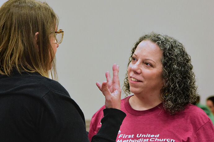 The Rev. Cathy Stone (right), associate pastor of First United Methodist Church of Austin, chats with a volunteer March 28 at the church. Stone is the driving force behind the church’s efforts to cater to the needs of unhoused people. Each Friday, volunteers provide women with food and pampering. Photo by Andrea Turner, UM News.