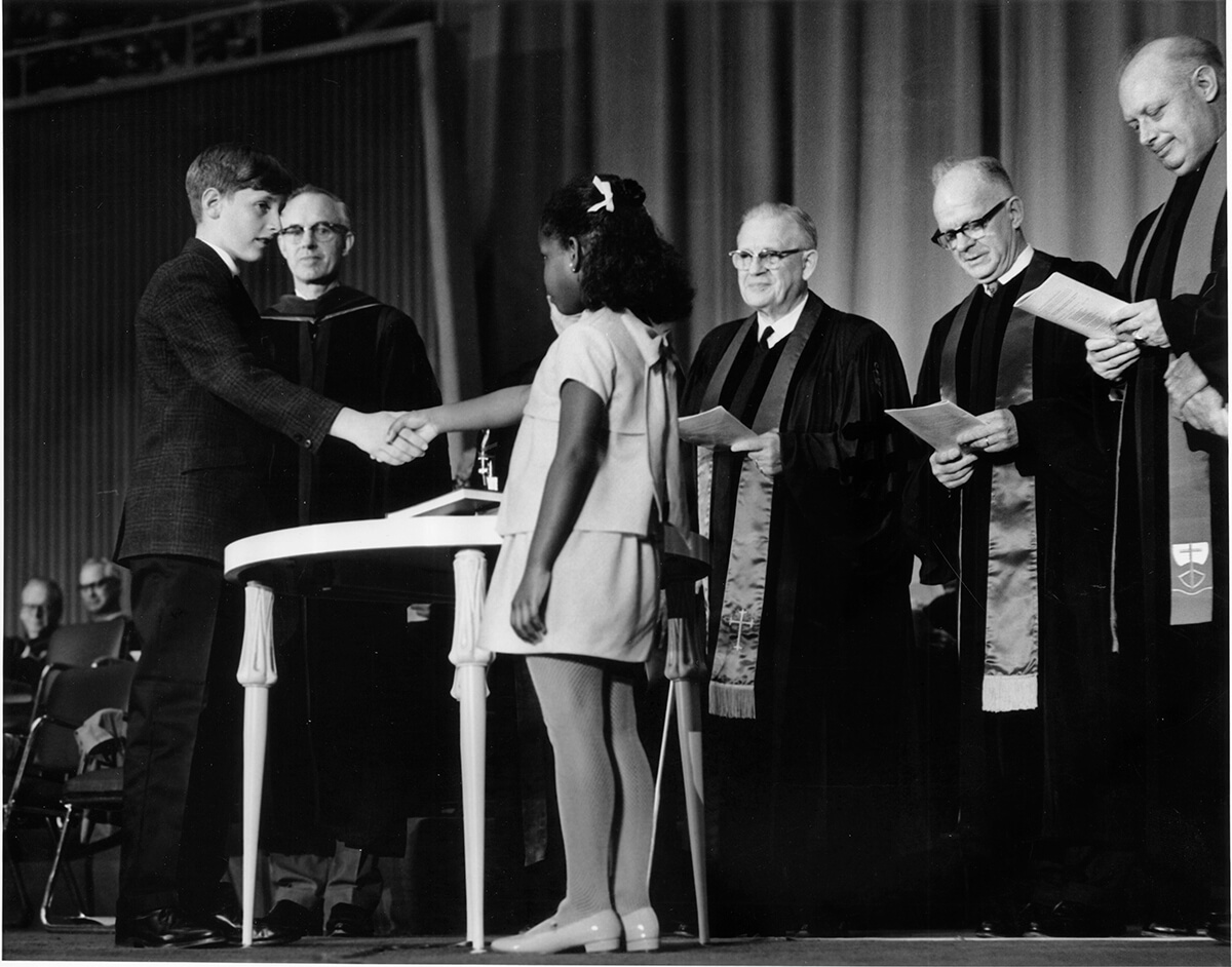 Robert O. Tupper II, representing the Evangelical United Brethren, and Rhonda Renfro, representing the Methodist Church, were the two children chosen to shake hands as part of the ceremony uniting the two denominations into The United Methodist Church, on April 23, 1968, in Dallas. In her new book, “Wesleyan Vile-tality: Reclaiming the Heart of Methodist Identity,” Ashley Boggan advocates for The United Methodist Church to return to its roots and stand with those in the margins. Photo courtesy of the United Methodist Commission on Archives and History.