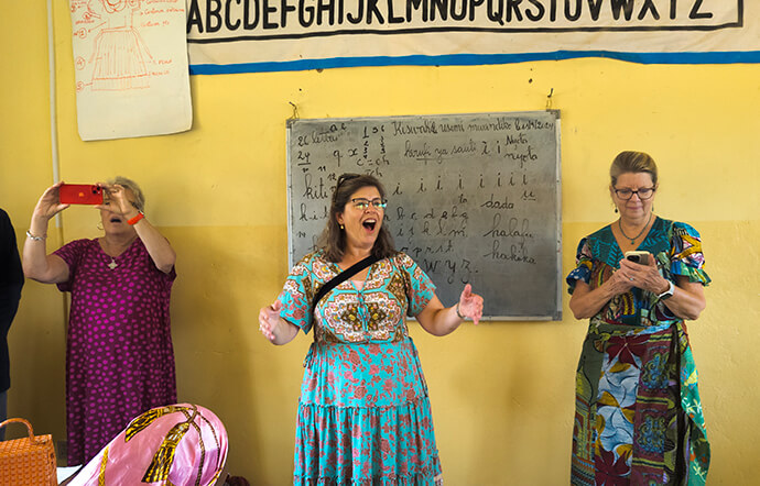 Amy Martin (center) teaches a song to students at the Mama Lynn Center in Kindu, Congo, during a visit by members of the Tennessee-Western Kentucky and California-Pacific conferences. The Rev. Birgitte French (left) and Linda Boulos look on. Through training and other support, the Mama Lynn Center helps women in Congo become economically independent. Photo by Chadrack Tambwe Londe, UM News.