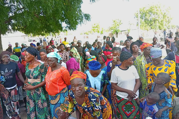 Community members affected by a violent attack in Karim Lamido, Nigeria, gather to receive aid from The United Methodist Church on June 4. The Nigeria Episcopal Area provided food, bedding and other supplies to survivors of the attack on local farmers, which left more than 40 dead, including 24 United Methodists. Photo by the Rev. Filibus Bakari Auta, UM News. 