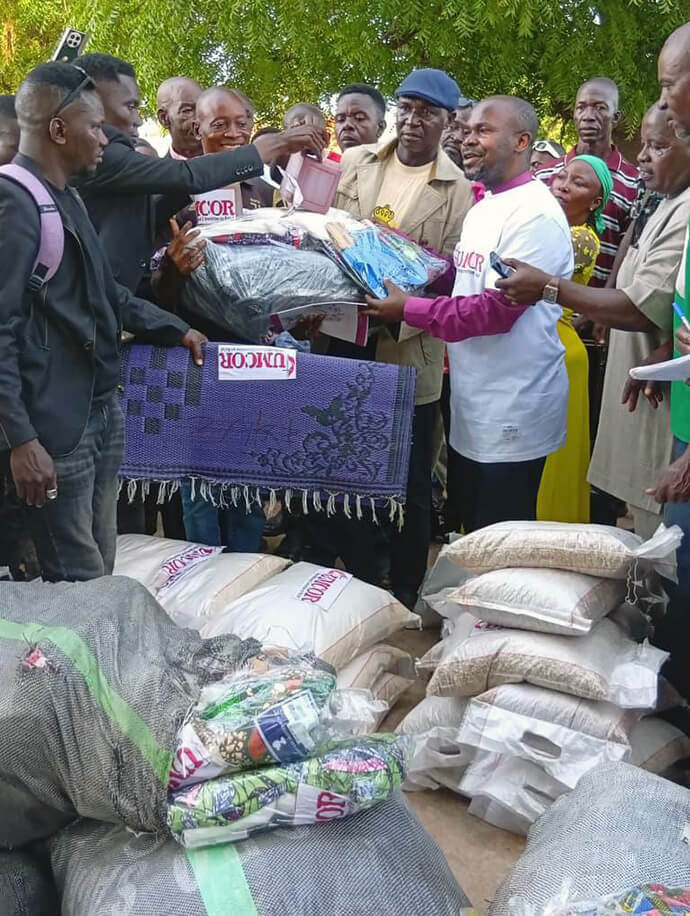Bishop Ande I. Emmanuel, who leads The United Methodist Church in Nigeria, helps distribute blankets and other relief to communities in Karim Lamido, Nigeria, on June 4, after a deadly attack on farmers in late May. Photo by the Rev. Filibus Bakari Auta, UM News. 
