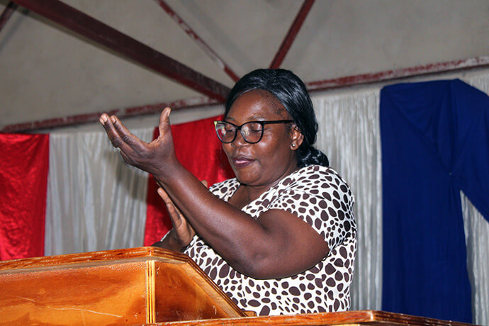 Emma Katema, an evangelist and interpreter at King Solomon United Methodist Church in Mutare, Zimbabwe, communicates during a stewardship and temperance session at the church. Katema said missionary Collins Kwasi Prempeh has motivated her to pursue her dream to be a pastor. Photo by Kudzai Chingwe, UM News.