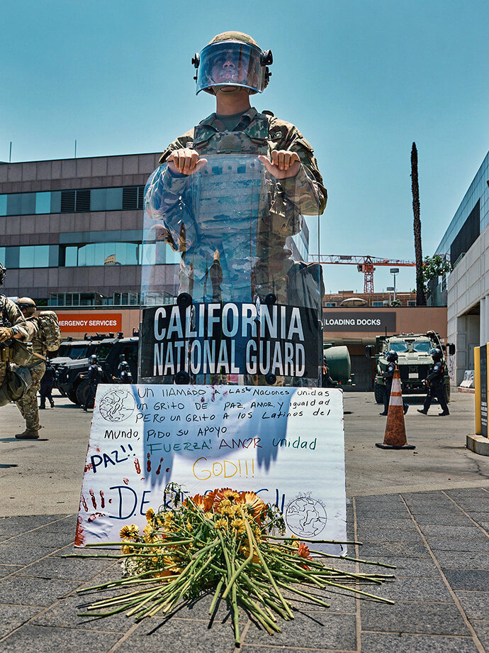 (Full view of top photo) A National Guardsman stands watch at a June 10 prayer vigil organized by the United Methodist-founded Clergy and Laity United for Economic Justice in downtown Los Angeles. The participants placed in front of him a poster in Spanish calling for peace, love and equality and asking for support. United Methodists across the Los Angeles area are working to stand up for immigrant rights while trying to de-escalate a tense situation as the Trump administration has deployed National Guard troops and Marines to quell protests against U.S. Immigration and Customs Enforcement. Photo courtesy of Clergy and Laity United for Economic Justice.