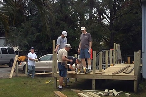 A crew from Ginghamsburg United Methodist Church in Tipp City, Ohio, builds a wheelchair ramp for a homeowner in Slidell, Louisiana, following Hurricane Katrina. Video image courtesy of Ginghamsburg United Methodist Church by UM News.