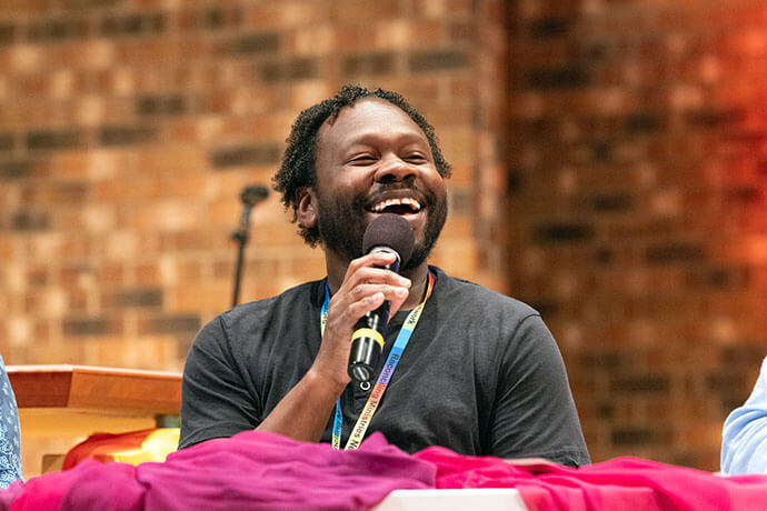 Derrick Scott III, a Reconciling Ministries Network board member and Florida Conference co-lay leader, celebrates the changes in the denomination thanks to Reconciling Ministries Network’s organizing. He also challenged Reconciling members to work more toward intersectional justice. Just speaking for himself, he said “queer inclusion is still a predominantly white conversation … queer inclusion is still a predominantly U.S.-centric conversation and still a predominantly ableist conversation.” Photo by Joscie Cutchens, UM News.