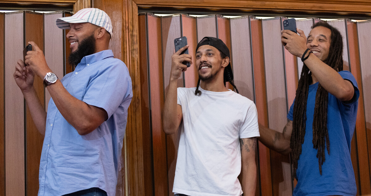 Proud fathers record their children performing a skit during the graduation ceremony for vacation Bible school at Hartzell Mt. Zion United Methodist Church. From left are Fred Washington, Michael DuPlessis and Eric Harrison.