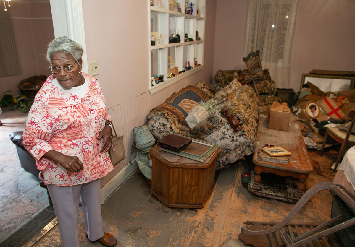 Dora Jackson, 77, surveys damage to her home in Slidell, La., after it was flooded by Hurricane Katrina.
