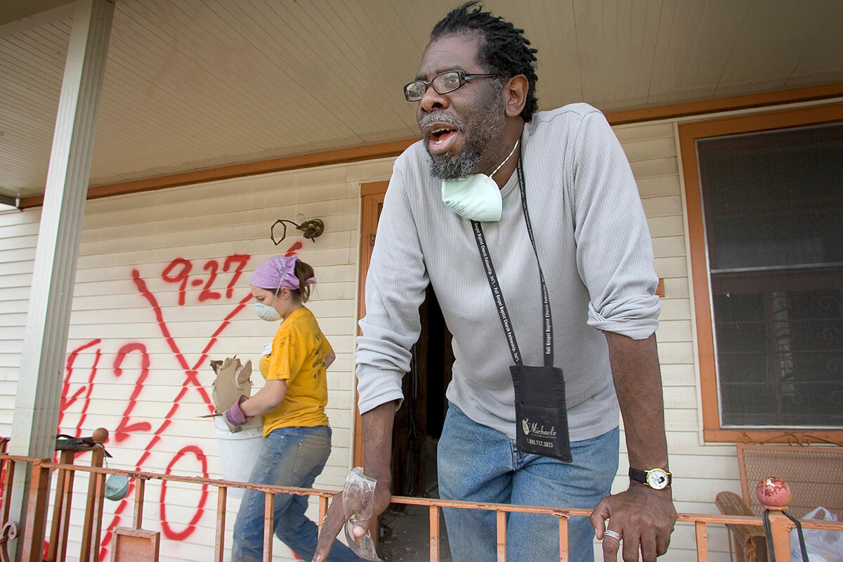 E. Dwight Franklin helps with the gutting of his parents’ home in New Orleans six months after Hurricane Katrina. Virginia Tech student Ivy Gorman (background) was part of a team from her school working through the Louisiana United Methodist Storm Recovery Center during their spring vacation. A UMNS photo by Mike DuBose.