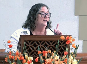 The Rev. Catie Coots, pastor of Community United Methodist Church, preaches at First United Methodist Church of Pasadena in 2024. Coots, who has been leading the wildfire-displaced Community congregation since April, said she believes the church can rebuild within three to five years with community involvement. Video image courtesy of YouTube by UM News.