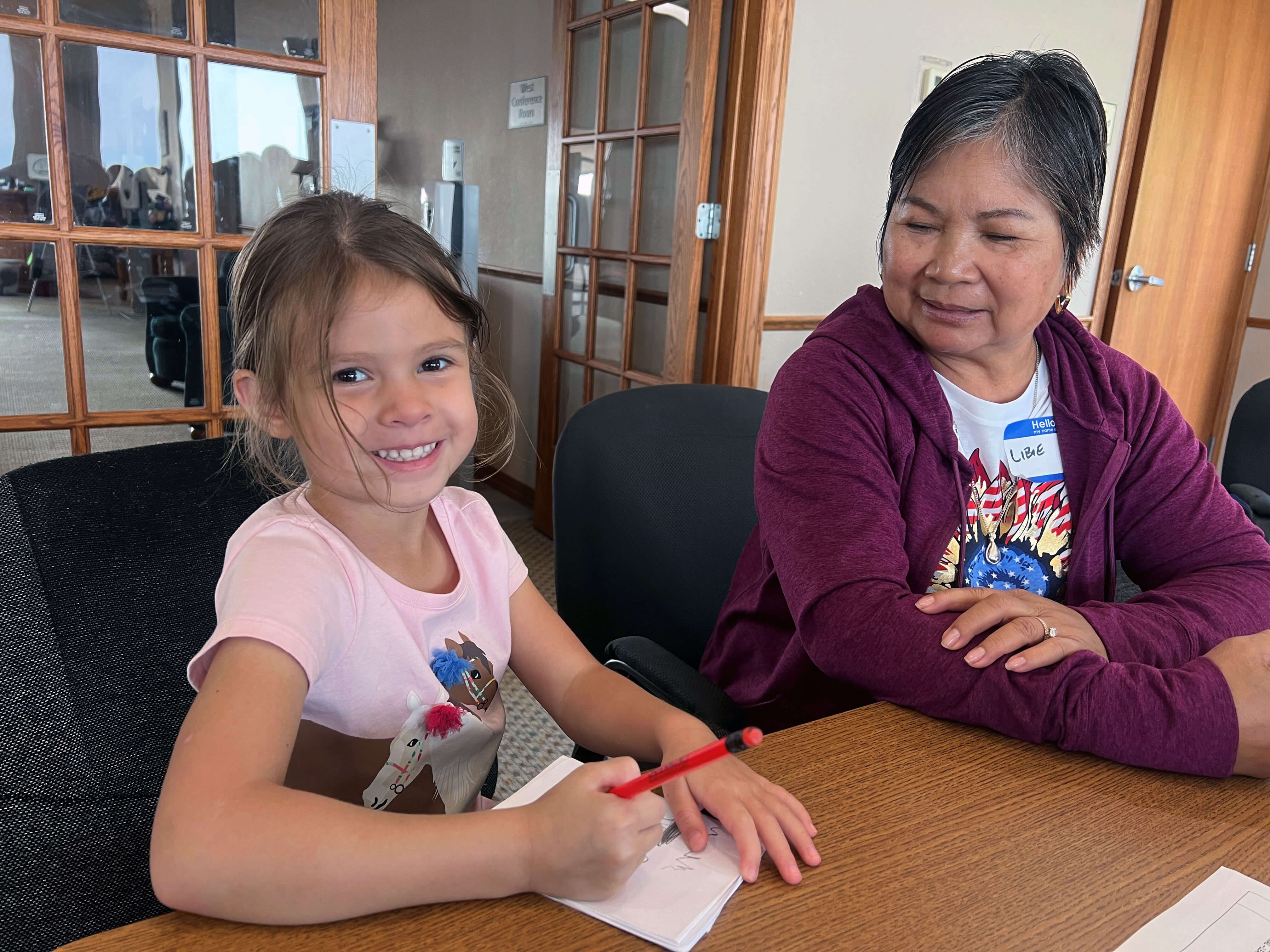 Libie Mills helps her granddaughter Jordyn Lathrop write a story as part of Grandparents and Me Camp at Lake Poinsett in Arlington, South Dakota. Photo by Lilla Marigza, UM News.