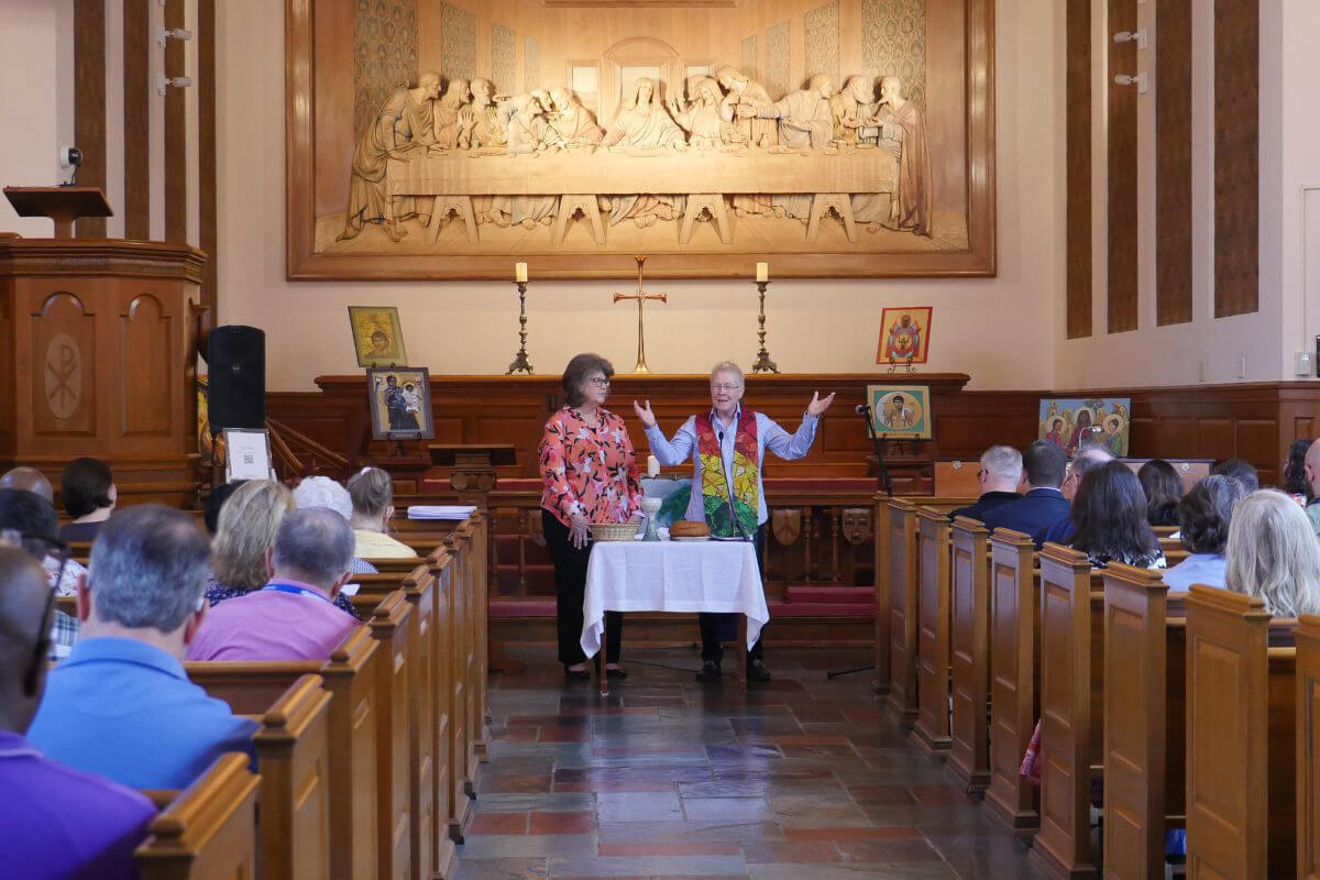 The Rev. Beth A. Richardson (right) consecrates the elements for Holy Communion as Sherry Elliott assists during a special service Aug. 20 in the Upper Room Chapel in Nashville, Tenn. The service was held as part of a celebration marking the 90th anniversary of The Upper Room devotional. Photo by Laura Buchanan, UM News.