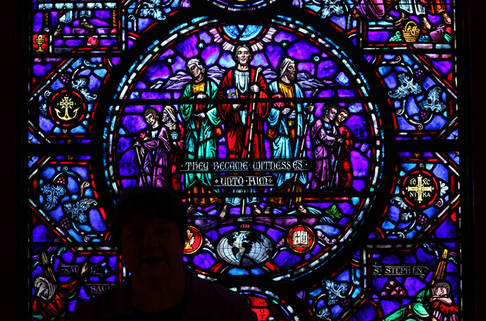 A woman stands silhouetted against a stained-glass window outside the Upper Room chapel in Nashville, Tenn. From its beginnings in 1935 as a daily devotional guide, The Upper Room has grown to include publications, programs, prayer support and other resources to help believers of all ages and denominations move to a deeper level of faith and service. File photo by Kathleen Barry, UM News.